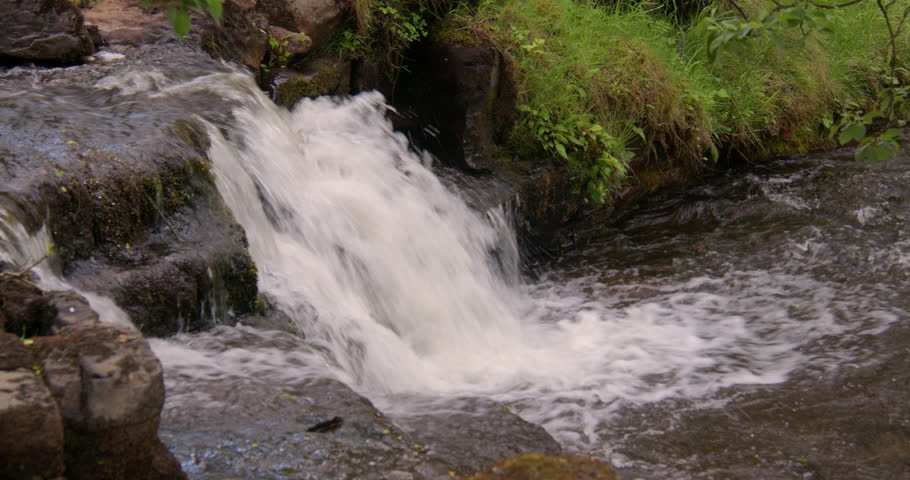 Shot of a small waterfall Entering the river swale, at keld, Swaledale