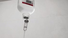 Intravenous fluid bag hanging delivering medication to patient in a hospital providing treatment and care - Powered by Shutterstock - Get 15% off with code: PIKWIZARD15