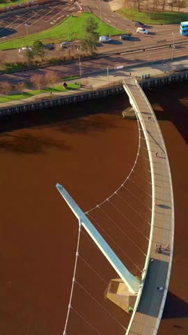 Overhead reversing social ratio aerial video of the Peace Bridge in Derry, County Londonderry in Northern Ireland. Produced in 1080x1920, 60FPS and with Rec709 color.