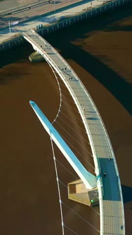 Reversing overhead social ratio aerial video of the Peace Bridge in Derry, County Londonderry in Northern Ireland. Produced in 1080x1920, 60FPS and with Rec709 color.