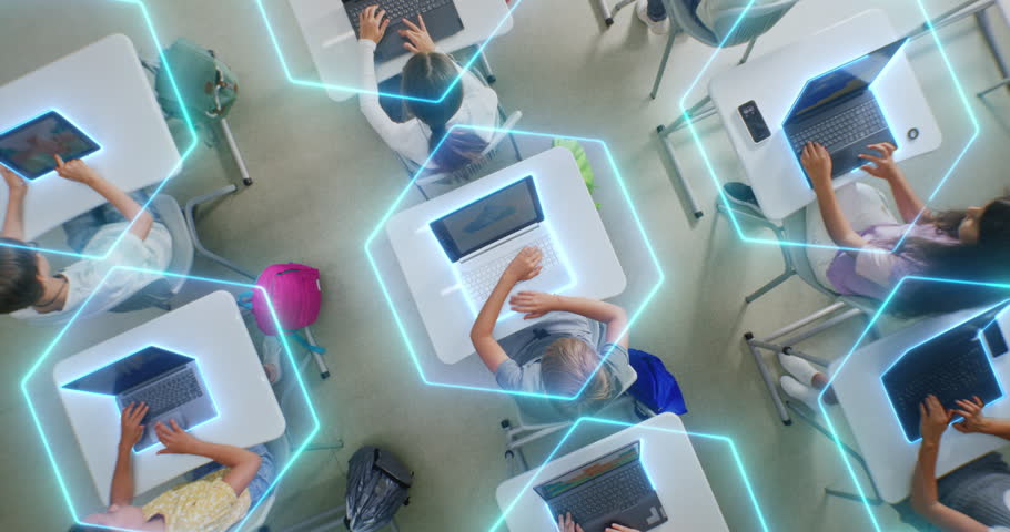 Children Sit at Desks Using Laptops, Surrounded by Luminous Digital Lines Symbolizing Virtual Connection and AI Collaboration. Technology Integration, and Future Focused Learning. Rotating Top View.
