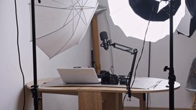 Professional podcast setup with camera, microphone, laptop, and studio lighting on table  - Powered by Shutterstock - Get 15% off with code: PIKWIZARD15