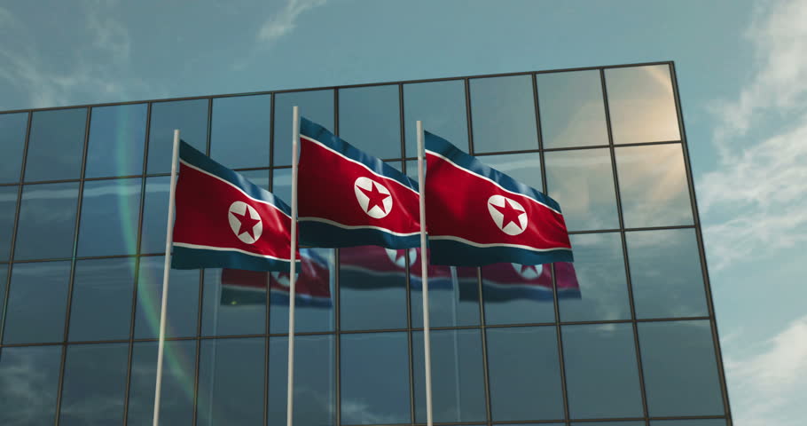 North Korea waving flag with glass building on backgroud. Korean blowing banner and reflection.