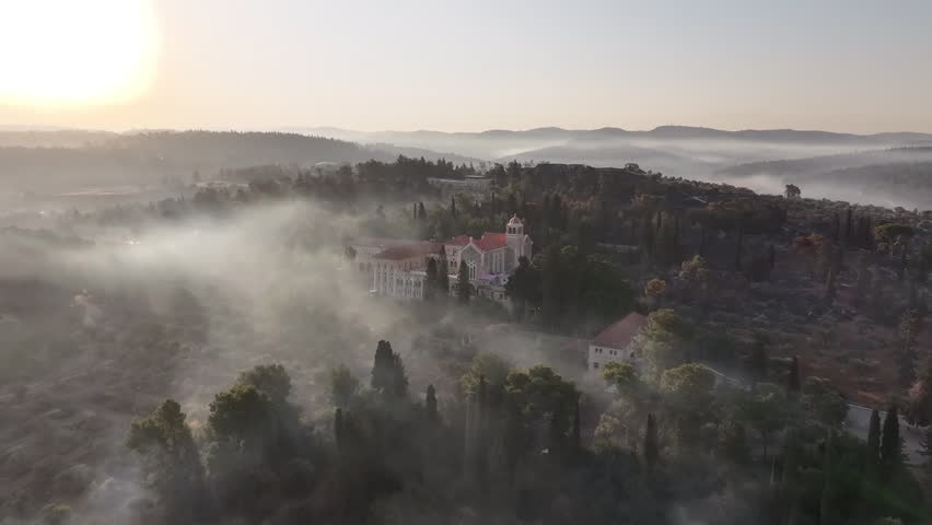 Drone footage showing smoke and haze surrounding the Latrun Monastery during the Jerusalem forest fires in Israel, April 2025, captured at sunrise .