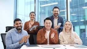 Group of business corporate people applauding look at camera sitting at workplace in office celebrate success. Happy satisfied successful professional diverse team colleagues rejoice achievement - Powered by Shutterstock - Get 15% off with code: PIKWIZARD15
