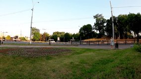 An energetic young man enjoys active recreation and parkour in the heart of Sumy, Ukraine. He performs a somersault on a grassy lawn next to blooming roses, symbolizing freedom, youth, and vitality. - Powered by Shutterstock - Get 15% off with code: PIKWIZARD15