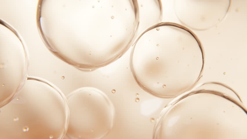 3D close-up of oil-based serum spheres with bounce effect. Perfect for beauty product visuals focused on elasticity and skin repair.