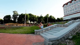 A young man practices a handstand near the Sadko Fountain in Sumy, Ukraine. He performs a controlled jump from the ledge to a handstand on the ground, demonstrating balance, strength, and precision - Powered by Shutterstock - Get 15% off with code: PIKWIZARD15