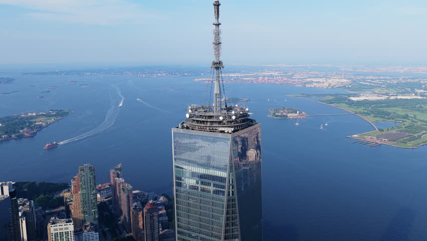 Aerial view of One World Trade Center in New York City, showcasing the iconic skyline and the bustling Hudson River