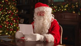 Merry Christmas. Happy Santa Claus reading letters from children in festive Christmas living room. Santa with xmas wish list letter on Christmas eve. Mail of Santa Claus. Winter Holiday Celebrations - Powered by Shutterstock - Get 15% off with code: PIKWIZARD15
