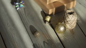 Holiday decor. Packing holiday gifts. Gift boxes, natural twine and Christmas gold balls on a wooden background. - Powered by Shutterstock - Get 15% off with code: PIKWIZARD15