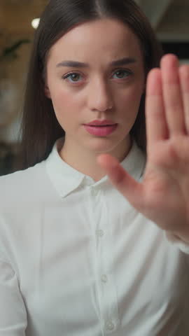Caucasian corporate woman serious confident displeased girl student worker employee female businesswoman looking at camera outstretch hand no reject stop gesture arm sign deny warn forbid dissatisfied