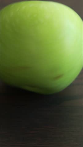 fresh green granny smith apple on dark background close up