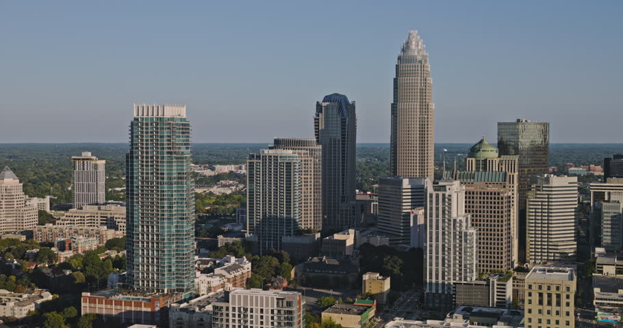 Charlotte North Carolina Aerial v60 cinematic low flyover Fourth Ward in the City Center capturing downtown skyscrapers cityscape set against a clear sky - Shot with Inspire 3 8k - Oct 1st 2023