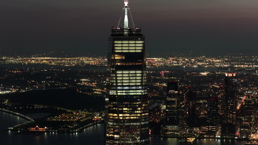 Aerial Night View of One World Trade Center in New York City, Illuminated Against the Dark Sky