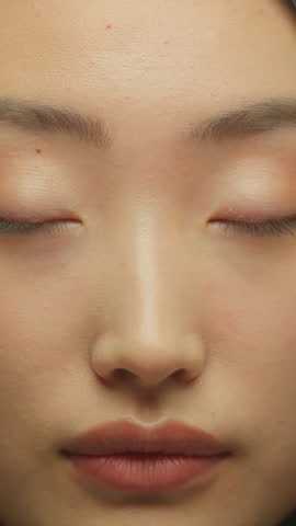 Pretty face Asian woman cute smiling looking at camera Chinese Korean ethnic girl Japanese female model smile indoors in studio beauty healthy smooth skin cosmetics make-up happy carefree cheerful