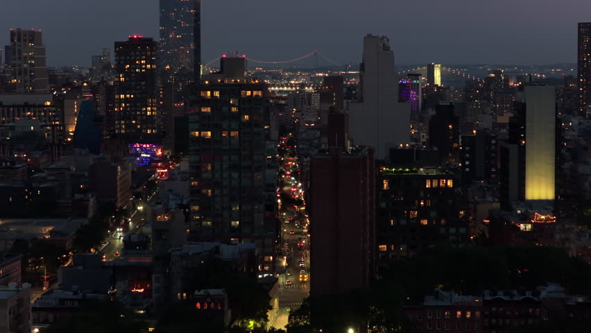 Aerial Night View of Manhattan, Featuring the Iconic Brooklyn Bridge at Distance and Illuminated Skyscrapers