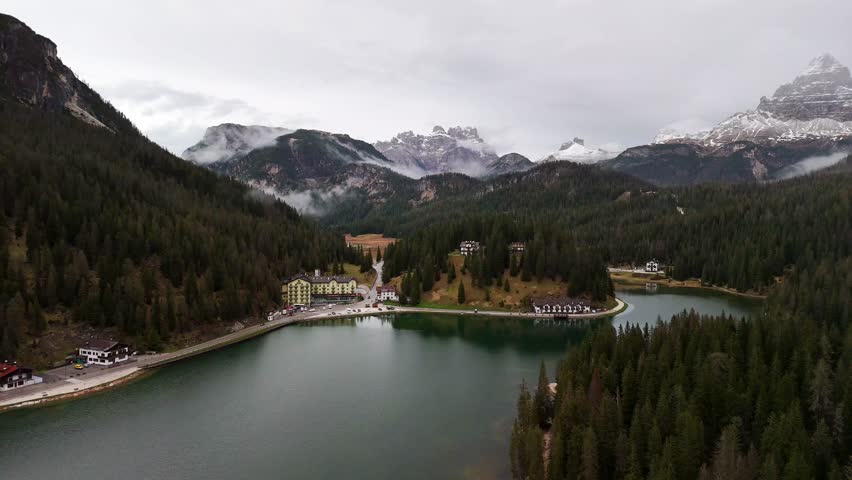 Editorial 4K aerial footage of Lago di Misurina surrounded by pine forests and Dolomite mountains, Italy. Misty weather and peaceful alpine scenery,15 September 2025,Editorial use only.