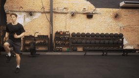 fit young man performing high-intensity knee drives during cardio interval with camera steadily pushing forward to emphasize determination - Powered by Shutterstock - Get 15% off with code: PIKWIZARD15