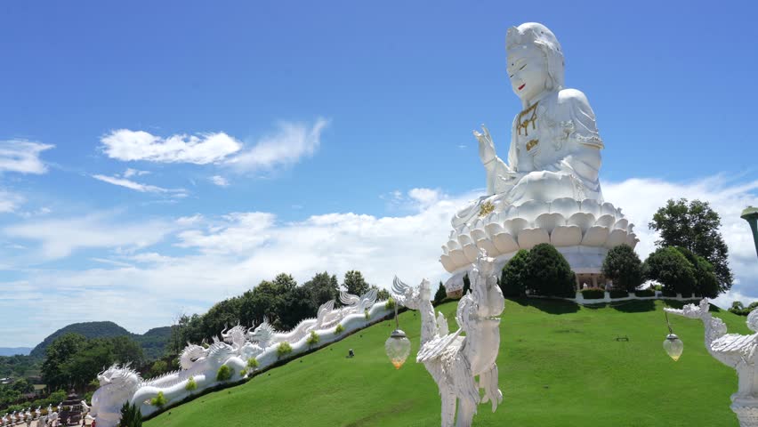 Wat Huay Pla Kang Temple, Great Buddha of Chiang Rai or giant goddess Guan Yin sitting on a lotus flower on a beautiful day with blue sky, Thailand.