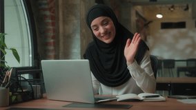 Smiling islamic muslim business woman in hijab smiling greeting hello talking video call with laptop in office ethnic girl female businesswoman communicate online conference computer virtual meeting - Powered by Shutterstock - Get 15% off with code: PIKWIZARD15