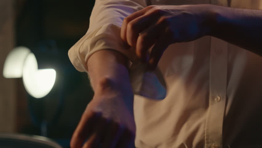 Unrecognizable business man rolling up sleeves adjusting collar shirt finishing job in evening night end work day in office textile stylish fashionable businessman luxury clothes prepare date male guy