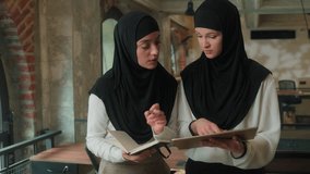 Two muslim business women in hijab corporate coworkers team managers arabian girls female businesswomen working together office cooperate discuss online project computer digital tablet writing notes - Powered by Shutterstock - Get 15% off with code: PIKWIZARD15