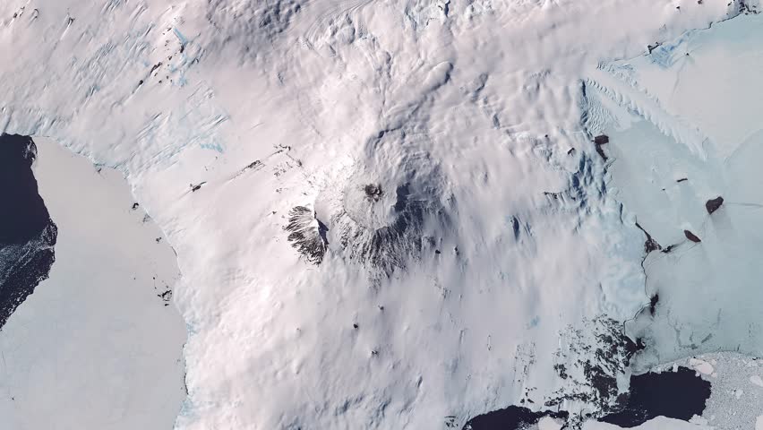 Panoramic top view of antarctic extinct volcano covered with snow. Camera is zooming in, rotating counterclockwise. Animation based on image by NASA