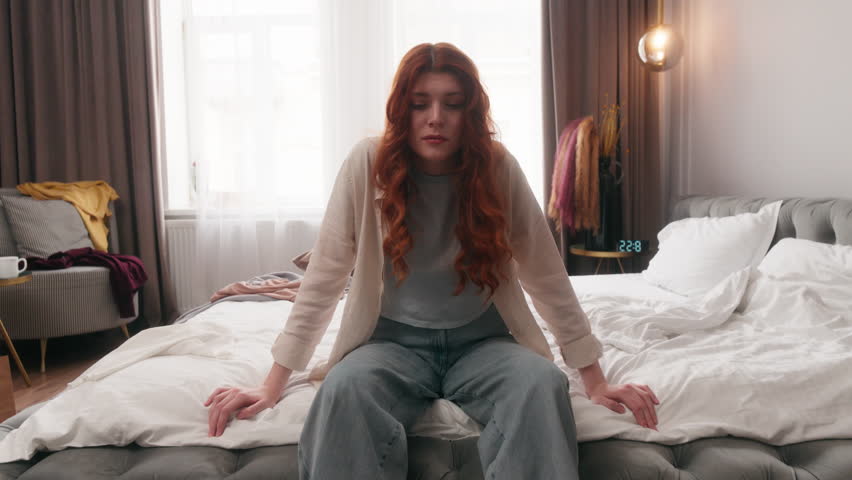 Caucasian woman yawn in messy dirty bedroom in morning yawning after party mess disorder tired girl overwhelmed homeowner at home cleaning stress female housewife lazy clutter chaos routine chore