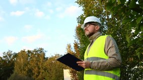 Inspector engineer using a tablet to take notes on a construction site. Male forestry studying the condition of trees in the forest. Work . Eco control. Ecologist conducting environmental monitoring.	 - Powered by Shutterstock - Get 15% off with code: PIKWIZARD15