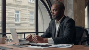 African American businessman talking business video call presenting diagram stats in office male CEO boss man leader employer showing documet stats financial result communicate conference negotiation - Powered by Shutterstock - Get 15% off with code: PIKWIZARD15