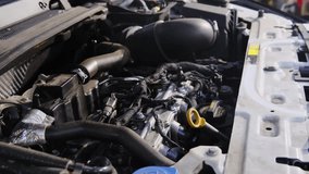 Vehicle engine with cables and pipes under open bonnet in repair shop closeup. Professional diagnostic of car motor problems at service station - Powered by Shutterstock - Get 15% off with code: PIKWIZARD15