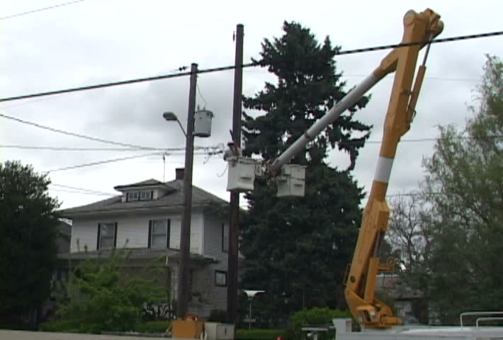Time Lapse of person from power company turning off power from power line.