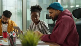 Multi-Ethnic entrepreneurs of informal business startup in office meeting diverse team work process in company workgroup, African American woman talk with Indian Arabian man strategy session planning - Powered by Shutterstock - Get 15% off with code: PIKWIZARD15