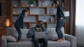 African American family irritated father work noisy kids jump on couch dad with laptop talking mobile phone annoyed busy near two children sons little boys jumping on sofa parenthood trouble stress - Powered by Shutterstock - Get 15% off with code: PIKWIZARD15