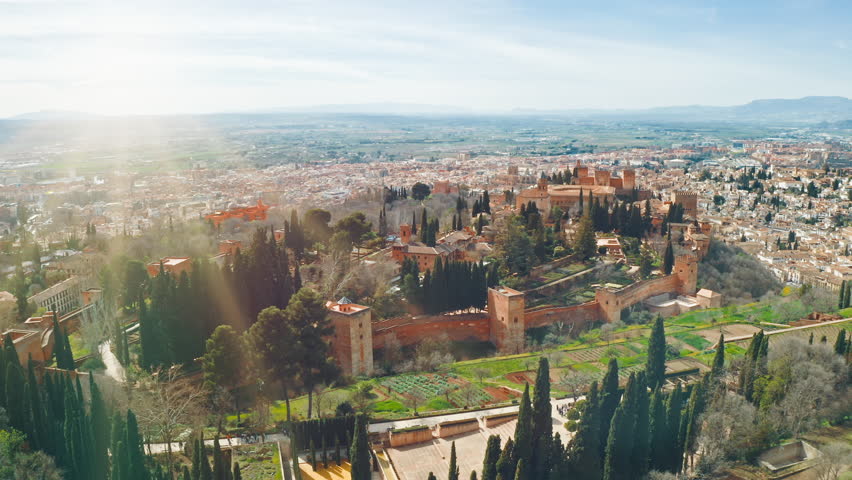 Aerial panoramic view of Alhambra fortress palace complex in Granada Spain with Sierra Nevada mountains historic Andalusian architecture UNESCO World Heritage site famous travel destination tourism