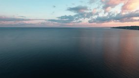 Aerial drone view of the Black Sea at sunrise. Calm water, soft pink clouds on the horizon, and deep morning colors create a peaceful, cinematic seascape - Powered by Shutterstock - Get 15% off with code: PIKWIZARD15