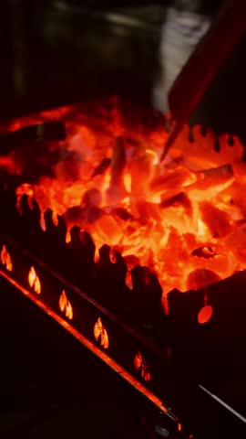 Metal mangal with coals. Wood and black coal fire flames on mangal. Burning wood barbecue on brazier. Fire Burns In Grill Brazier. Picnic In Nature. Charcoal Burning With Flames And Blaze