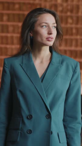 Portrait of serious business woman dressed elegant suit looking directly at camera. Footage of successful restaurant owner with hands folded in background of modern interior. Indoors, person