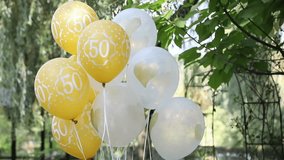 Bright yellow and white balloons with the number 50, symbolizing a festive anniversary or birthday celebration. Perfect for illustrating milestone events, party decorations, or cheerful holiday backgr - Powered by Shutterstock - Get 15% off with code: PIKWIZARD15