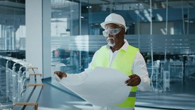 Mature African American businessman reviewing plans in corporate office setting - Powered by Shutterstock - Get 15% off with code: PIKWIZARD15