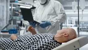 Doctor in biohazard lab conducts medical trial on a contagious patient, studying disease transmission, symptoms and antiviral drug effectiveness to develop treatments in virology. Camera B. - Powered by Shutterstock - Get 15% off with code: PIKWIZARD15