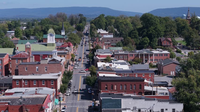 Explore the beauty of Charles Town, West Virginia, with an aerial view of the main street, showcasing the courthouse and vibrant autumn colors in the landscape.