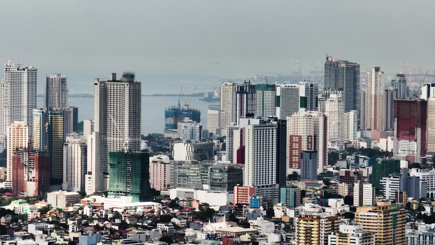 Business office buildings and high rise towers in Makati. Blue sky and clouds. Metro Manila, Philippines.
