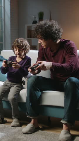 Warm Evening Light, Father and Son Playing Video Game on Couch, Family Time, Cozy Home Interior, Joy, Love, Happiness, Modern Parenting, Technology and Childhood Connection