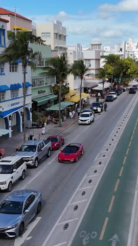 Title: Coastal Miami street with cafes on sunny day tourism in Florida. Vertical video.