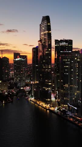 Aerial night view of Miami business center at sunset dusk. Vertical video.