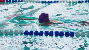 Competitive Swimming: A Dedicated Athlete in Motion, Showcasing Technique and Determination During a Swim Practice Session in a Dynamic Training Environment - Powered by Shutterstock - Get 15% off with code: PIKWIZARD15