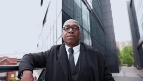 Confident man in formal attire stands in urban setting with modern buildings in the background during daytime - Powered by Shutterstock - Get 15% off with code: PIKWIZARD15