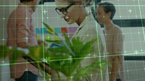 Businesswoman tapping tablet activating AR grid as team passing folder moving sticky notes to plan. Collaboration, innovation, digital, workspace, teamwork, brainstorming, technology - Powered by Shutterstock - Get 15% off with code: PIKWIZARD15